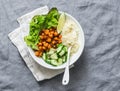 Detox moroccan spiced chickpea glow bowl on a grey background, top view. Vegetarian food