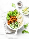 Detox moroccan spiced chickpea glow bowl on a light background, top view. Vegetarian food