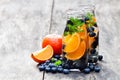 Detox organic blueberry and orange drink on wooden background