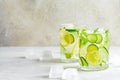 Detox sassy water with cucumber and lemon in glass, light background. Healthy eating concept