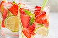 Detox sassy water with strawberries and lime in glasses. Healthy eating concept