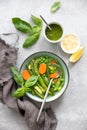 Detox vegetable spring soup, green minestrone inspired recipe, overhead view on ready to eat dish