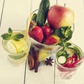 Detox water cocktail. Fresh vegetables and fruits in a glass bowl. Strawberry, apple, cucumber, lemon and mint. Royalty Free Stock Photo