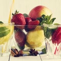 Detox water cocktail. Fresh vegetables and fruits in a glass bowl. Strawberry, apple, cucumber, lemon and mint. Royalty Free Stock Photo