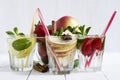 Detox water cocktail. Fresh vegetables and fruits in a glass bowl. Strawberry, apple, cucumber, lemon and mint. Royalty Free Stock Photo