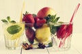 Detox water cocktail. Fresh vegetables and fruits in a glass bowl. Strawberry, apple, cucumber, lemon and mint. Royalty Free Stock Photo