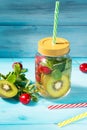 Detox water cocktail with fresh kiwi fruit, cherry berries and mint