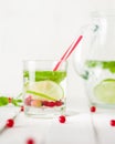 Detox water in a glass jug and a glass. Berries and lime, red and green. Fresh mint leaves. Royalty Free Stock Photo