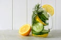 Detox water with lemon, cucumber, in jar over white wood Royalty Free Stock Photo