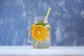 Detox water with lemon, orange and mint. Glass jar.The concept i