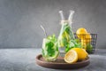Detox water or lemonade with lemon mint, citrics in glass on wooden table and grey backdrop Royalty Free Stock Photo