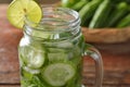 Detox water with lime and cucumbers in mason jar against a rus Royalty Free Stock Photo