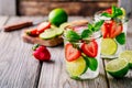 Detox water with strawberry, lime and mint. Ice cold summer cocktail or lemonade in glass mason jar Royalty Free Stock Photo