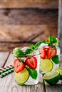 Detox water with strawberry, lime and mint. Ice cold summer cocktail or lemonade in glass mason jar Royalty Free Stock Photo