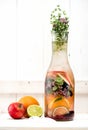 Detox Water Summer lemonade with berries, herbs and fruits in a glass bottle