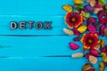 Detox word on blue wood with flower