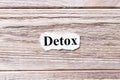 Detox of the word on paper. concept. Words of detox on a wooden background