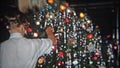 DETROIT, MICHIGAN 1953: Teenager posing in front of Christmas tree nativity scene.