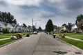 A suburban street with houses being evicted and people belongings on the lawns near the 8 mile road, in the city of Detroit