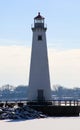 Detroit riverfront lighthouse during cold winter facing Canada