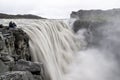 Dettifoss waterfall in Iceland after floods filled with muddy water and tourists