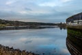 Deugh Dam and fish farm at Kendoon Loch, at sunset in winter, Galloway, Scotland