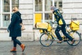 Deutsche post courier riding a bike on a street in a german town Royalty Free Stock Photo