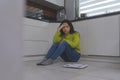 Devastated dieting young asian woman sitting on the flor with weight scale in front. Weight loss and mental health Royalty Free Stock Photo