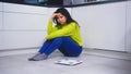 Devastated dieting young asian woman sitting on the flor with weight scale in front. Weight loss and mental health Royalty Free Stock Photo