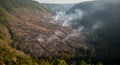Devastated Forest Landscape with Smoke Rising After Deforestation, Environmental Destruction Royalty Free Stock Photo