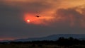 Devastating wildfire in Alexandroupolis Evros Greece, Aerial firefighting waterbombing planes, smoke covered the sky, sunset