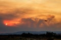 Devastating wildfire in Alexandroupolis Evros Greece, Aerial firefighting waterbombing planes, smoke covered the sky, sunset