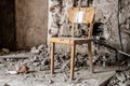 Old wooden chair in devasted abandoned room