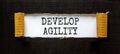 Develop agility symbol. Concept words Develop agility on beautiful white paper on a beautiful black background. Business, support Royalty Free Stock Photo