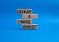 Develop a change mindset symbol. Concept words Develop a change mindset on wooden blocks. Beautiful blue background. Business and