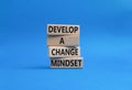 Develop a change mindset symbol. Concept words Develop a change mindset on wooden blocks. Beautiful blue background. Business and
