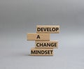 Develop a change mindset symbol. Concept words Develop a change mindset on wooden blocks. Beautiful grey background. Business and