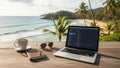 Developer coding on laptop at tropical beach with coffee and sunglasses Royalty Free Stock Photo