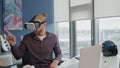 Developer experience virtual reality in office. Focused man exploring future