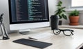 Programmer\'s Desk Setup: Computer Screen with Code, Keyboard, Glasses, and Coffee Royalty Free Stock Photo