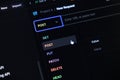 Developer selecting POST method for a new API request in a dark mode programming interface, illustrating software development and Royalty Free Stock Photo