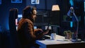 Developer typing complex code in neon lit home office, listening music
