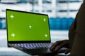 Developer uses green screen laptop to do checkup on data center electronics Royalty Free Stock Photo