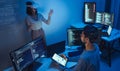 developer uses a VR headset to interact with projected interface designs, while colleagues discuss and code on screens,