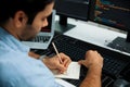 IT developer writing data memo software development on paper& x27;s coding. Surmise. Royalty Free Stock Photo