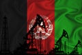 Developing Flag of Afghanistan. Silhouette of drilling rigs and oil rigs on a flag background. Oil and gas industry. The concept