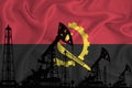 Developing Flag of Angola. Silhouette of drilling rigs and oil rigs on a flag background. Oil and gas industry. The concept of oil