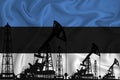 Developing Flag of estonia. Silhouette of drilling rigs and oil rigs on a flag background. Oil and gas industry. The concept of