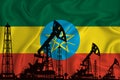 Developing Flag of ethiopia. Silhouette of drilling rigs and oil rigs on a flag background. Oil and gas industry. The concept of