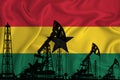 Developing Flag of Ghana. Silhouette of drilling rigs and oil rigs on a flag background. Oil and gas industry. The concept of oil